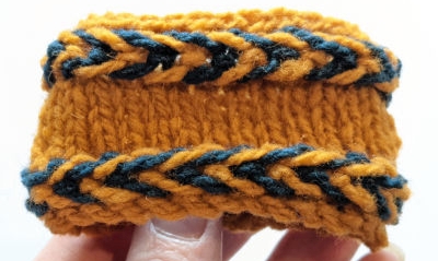 Two bands of Latvian braid, pointing right and left