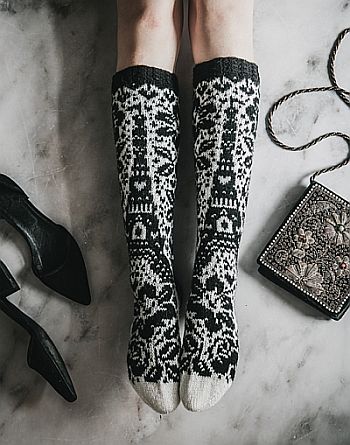 Black and white stranded knitting knee-length socks, depicting the Eiffel tower surrounded by flowers