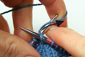 Forming the new stitch with the yarn held in the left hand